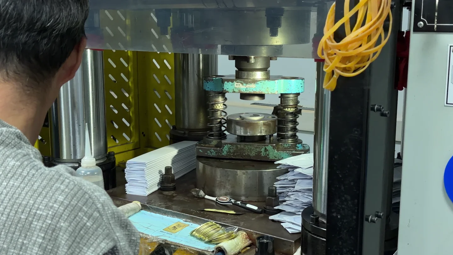 An operator at a dial production station